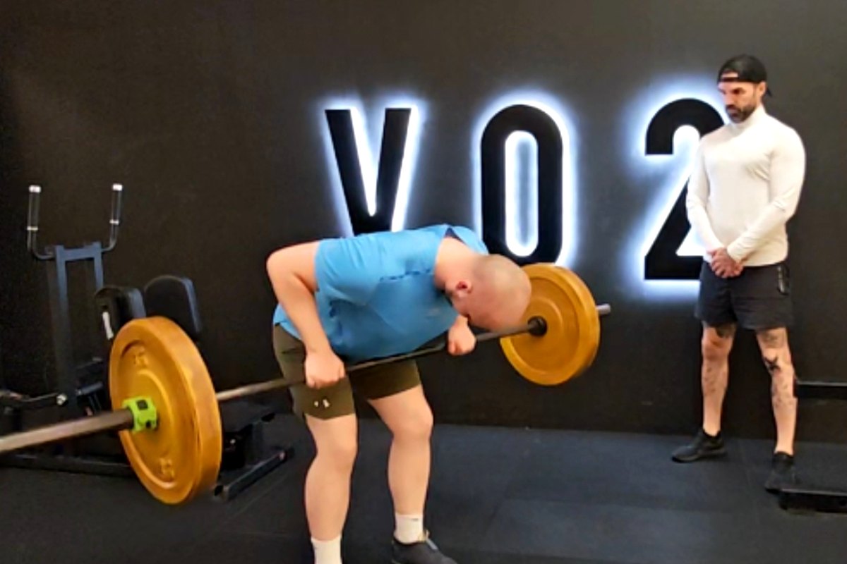Ian Wilson coaching a client through a bent-over barbell row at Vo2 in Portadown