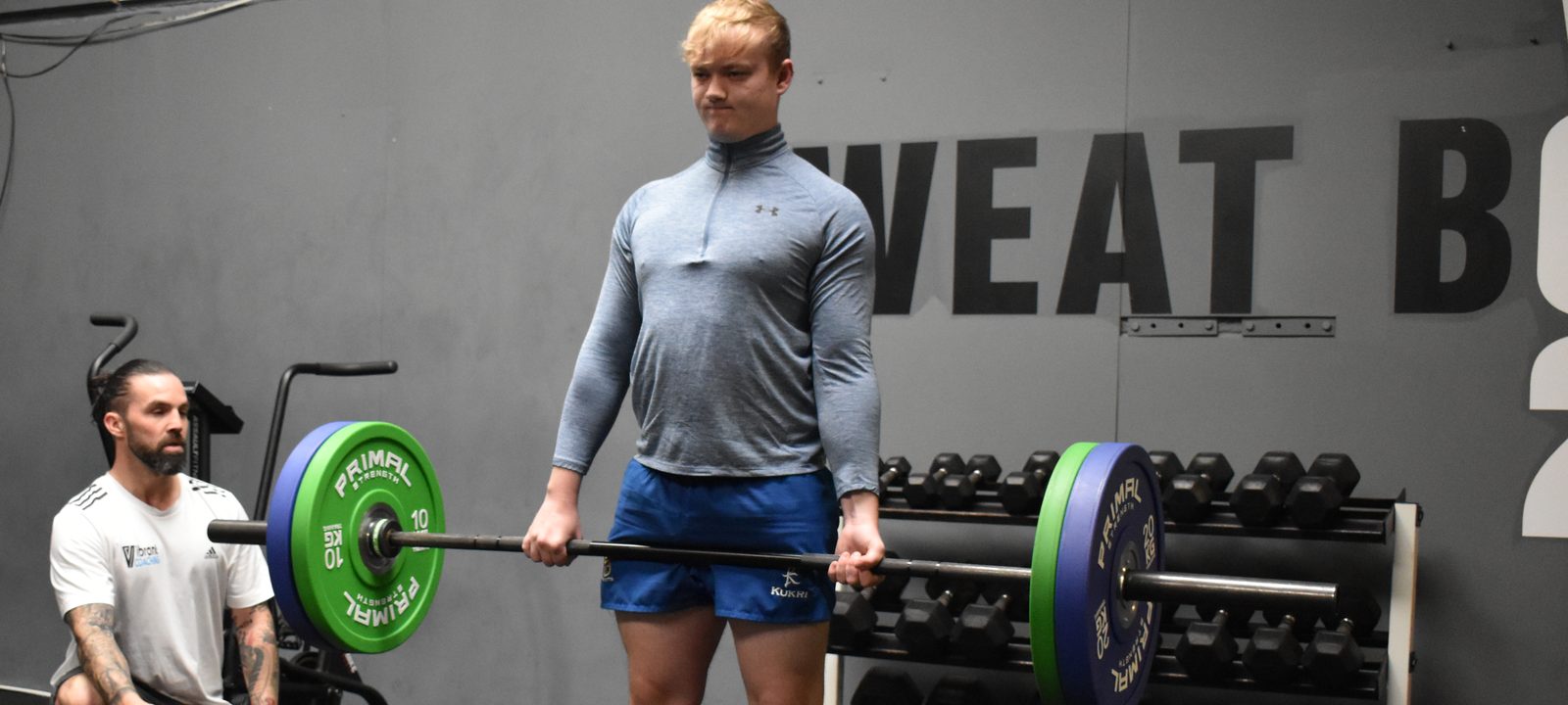 A client performing a barbell deadlift while Ian Wilson coaches alongside at Vo2 gym in Portadown